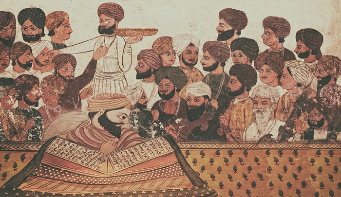 A granthi reading the Guru Granth Sahib before the sangat